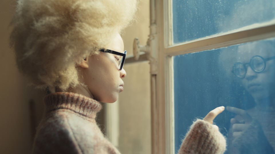 Hawa, the film's protagonist, looking out of a window