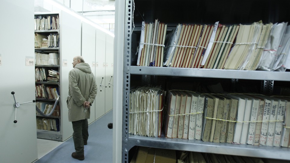 A visitor looks at a shelf containing documents during a public day at the Federal Department for the Stasi Records in Berlin.