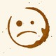 a sad face that looks like a coffee stain