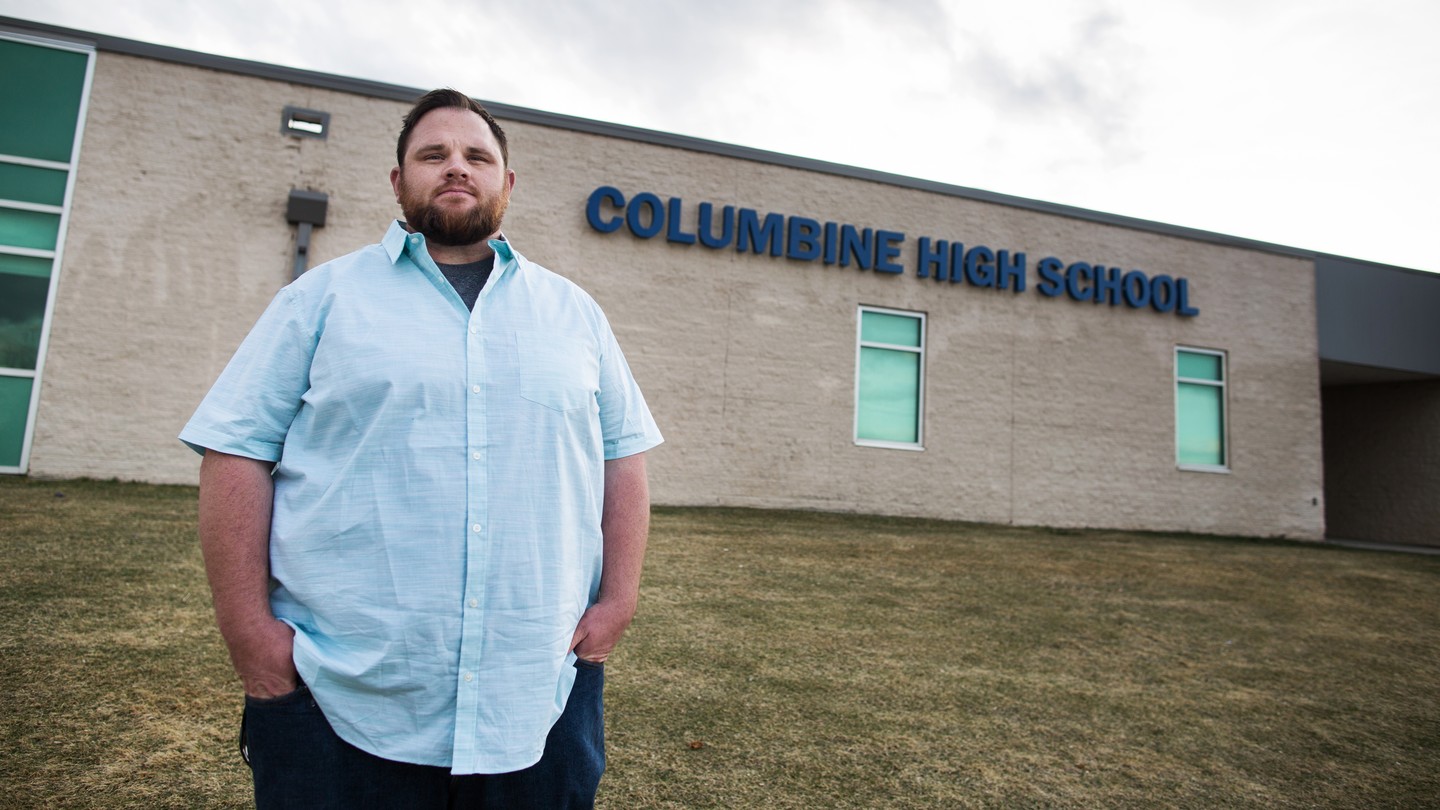 Evan Todd in front of Columbine High School, where he narrowly escaped as a student.