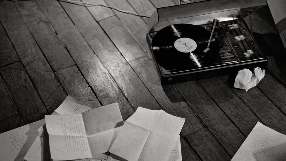 A record player and notes strewn across the floor