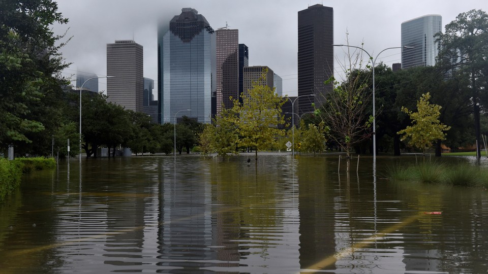 The downtown skyline reflected in the floodwater at Buffalo Bayou Park in Houston