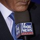Close-up picture of Donald Trump's mouth speaking to a Fox News microphone.