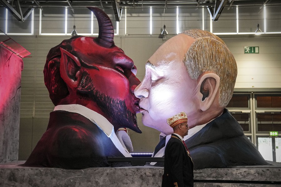 A Carnival float depicts Vladimir Putin kissing the devil.