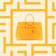 A yellow Birkin bag against a yellow background