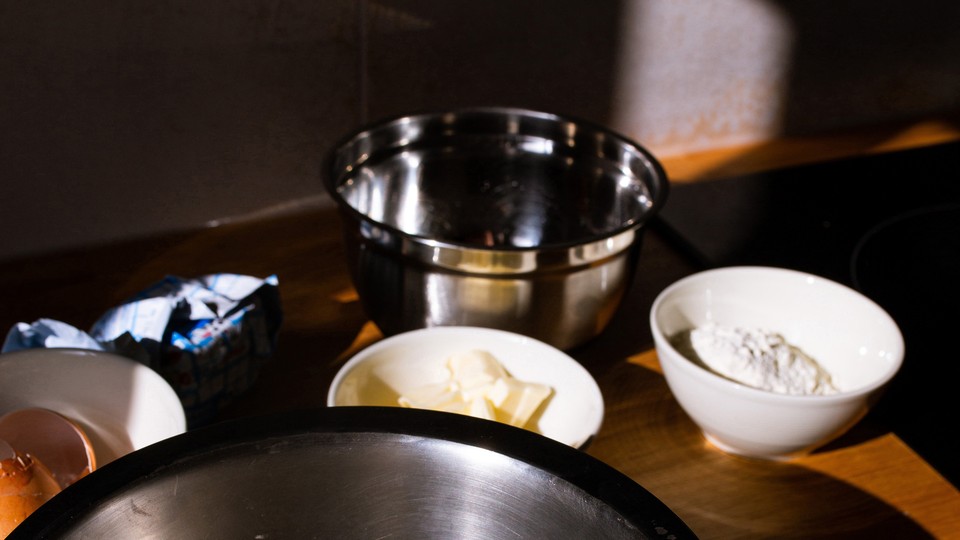 Photograph of bowls containing flour, butter, eggs, and other baking ingredients