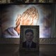 A framed photograph of the victim of a shooting in Manila lies atop his casket.