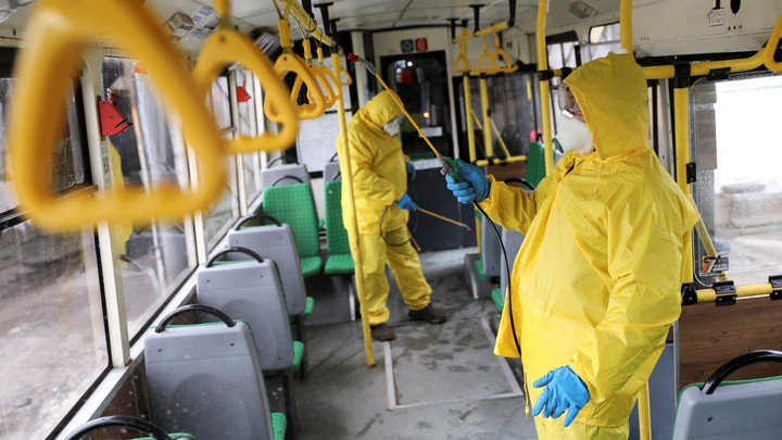 Workers sanitizing a bus in Ukraine.