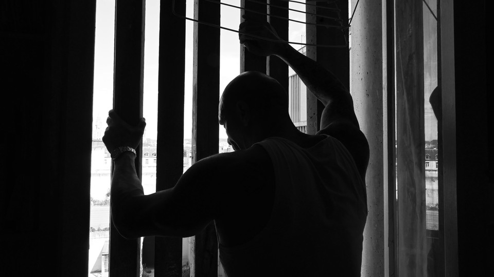 prisoner holding onto bars