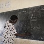 A mathematics teacher writes on the chalkboard at the Juba One Girls Basic Education School, in South Sudan, in 2012.