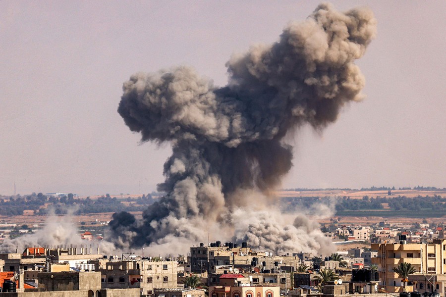 A huge plume of smoke and dust rises above buildings in Gaza.