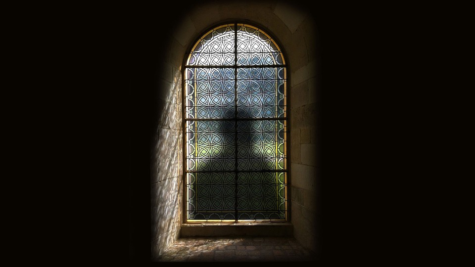An illustration of a shadow behind a stained-glass window