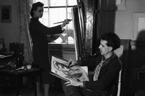 A man sketches a woman painting at her easel