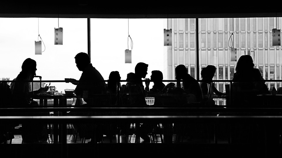 Silhouettes of people sitting in a restaurant