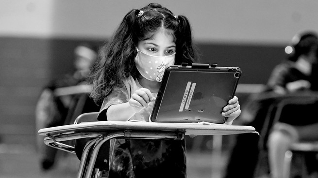 Child in classroom wearing a mask