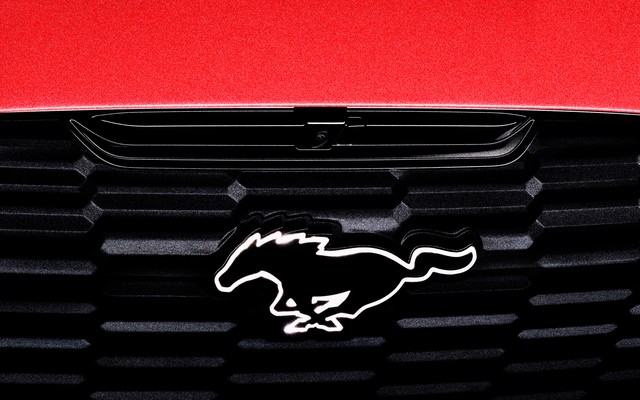 the front bumper of a Ford Mustang Mach-E, showing the galloping-horse logo