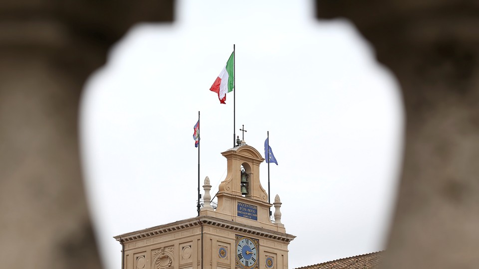 The Italian flag flutters at the Quirinal Palace during the two-day talks on government formation, after the March national elections, in Rome on April 4, 2018