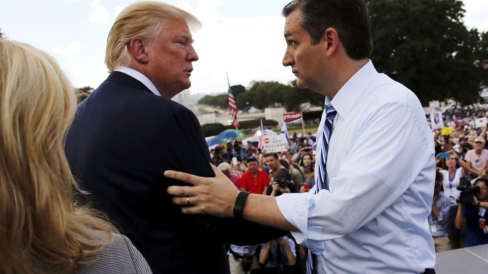 Ted Cruz greets Donald Trump onstage as they address a Tea Party rally in September 2015.