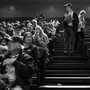 A black-and-white photo of Iowans caucusing