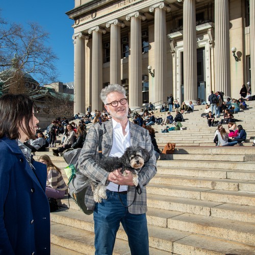 Adam Tooze stands on Columbia University's Campus outdoors.