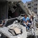 Palestinian children watch a band perform from the rubble of a building destroyed by Israeli air strikes.