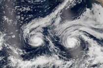 A tropical storm and a hurricane approach Hawaii as seen from satellite images. 