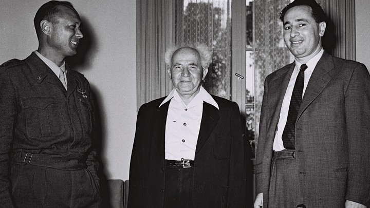 David Ben-Gurion, center, then Israel's defense minister, stands with Moshe Dayan, the military's Chief of Staff, left, Shimon Peres, the director general of the Ministry of Defense in Tel Aviv on February 2, 1955.
