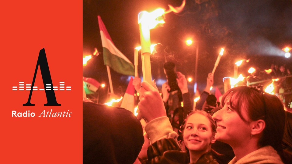 A crowd celebrates Hungarian-election results, waving flags and holding candles.