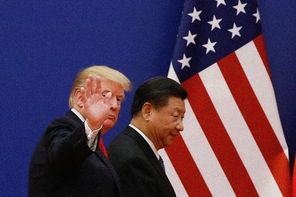 Donald Trump and Xi Jinping are positioned in front of an American flag.