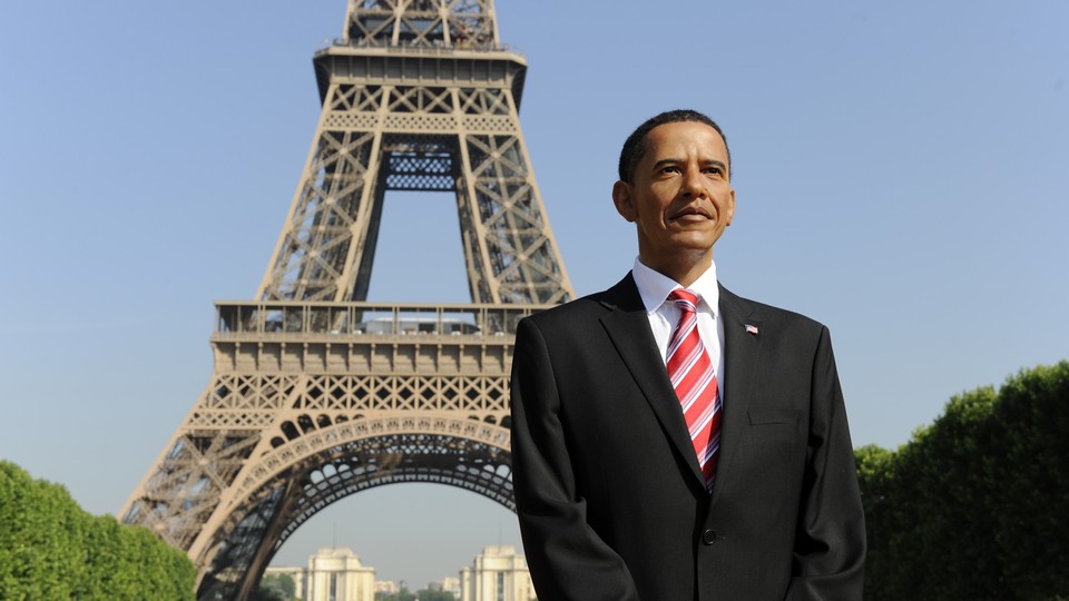 A wax statue of former President Barack Obama stands in front the Eiffel Tower before its installation at the Grevin Museum in Paris on June 29, 2009. 