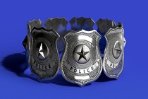 A circle of silver police badges standing against a blue background