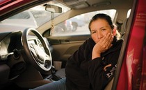 Alma Alvarez sitting in the front seat of her car
