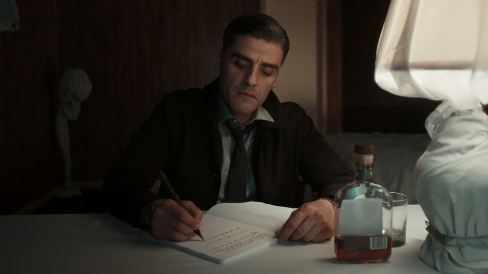 Oscar Isaac writes in a diary in "The Card Counter."