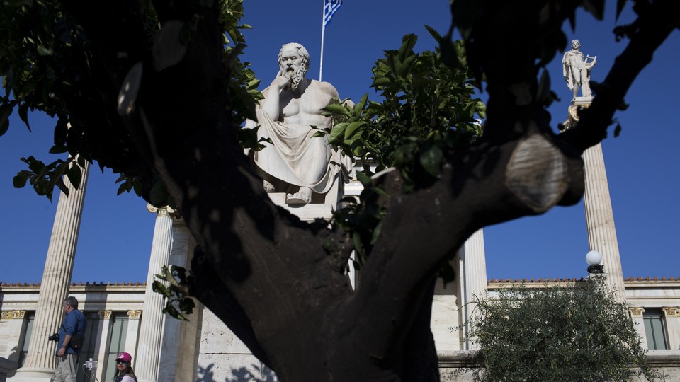 A statue of Socrates is visible behind a tree. 