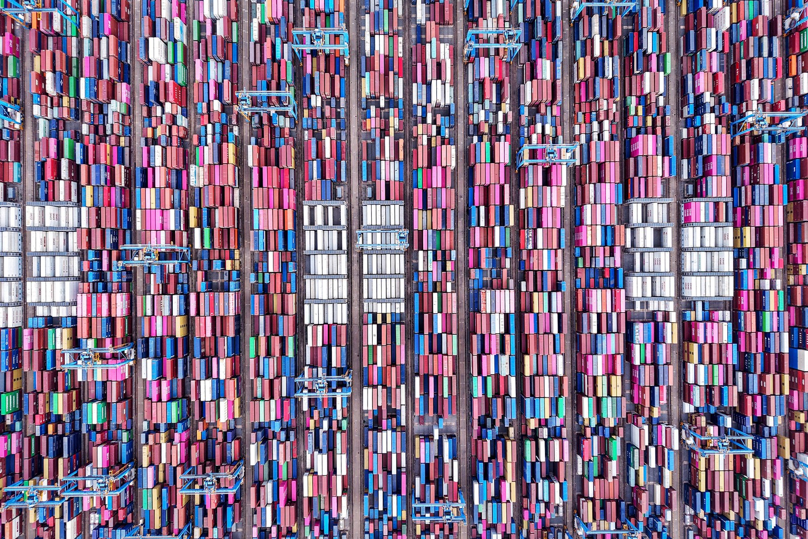 An aerial view of many cargo containers at a port.