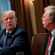 Donald Trump crosses his arms as he speaks with John Bolton.