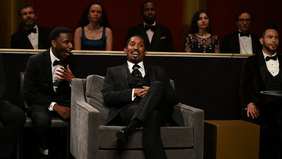 A scene from "SNL" depicting Will Smith and a seat filler at the Oscars
