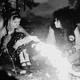 Yellowjackets cast members around a fire