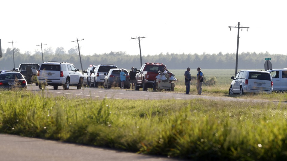 Emergency personnel stand along U.S. Highway 82 following the plane crash on July 10, 2017.