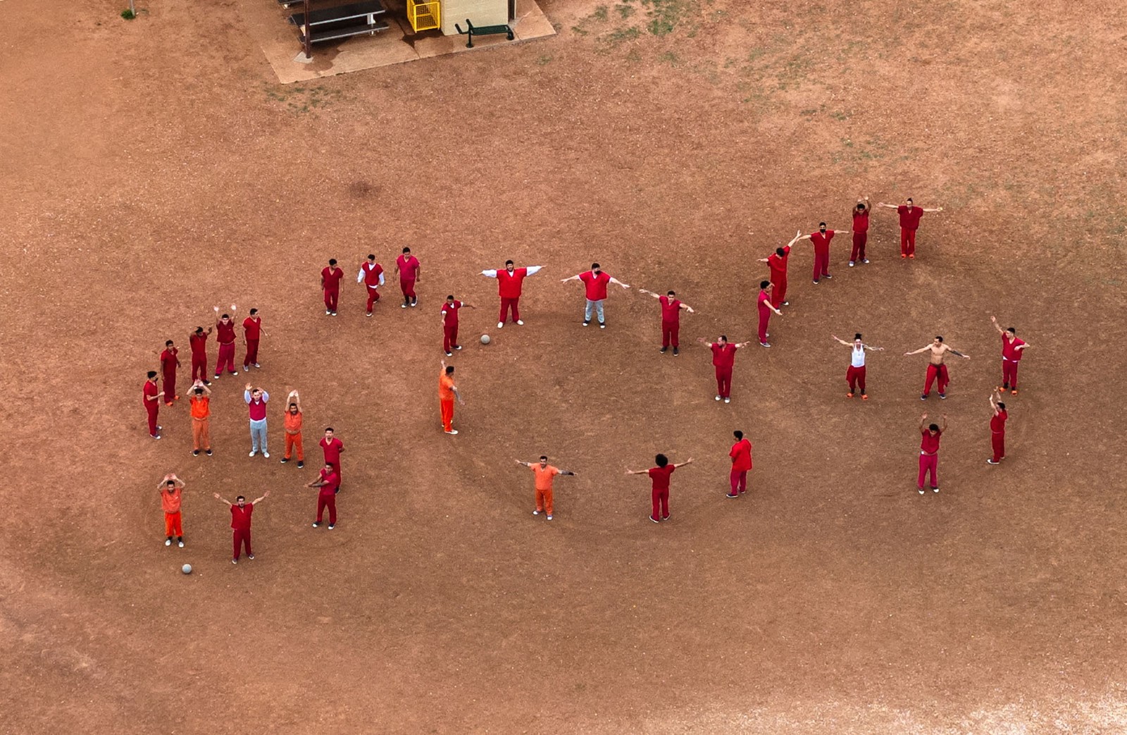 Dozens of prisoners form the letters