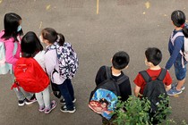 children in masks gathered at a New York elementary school