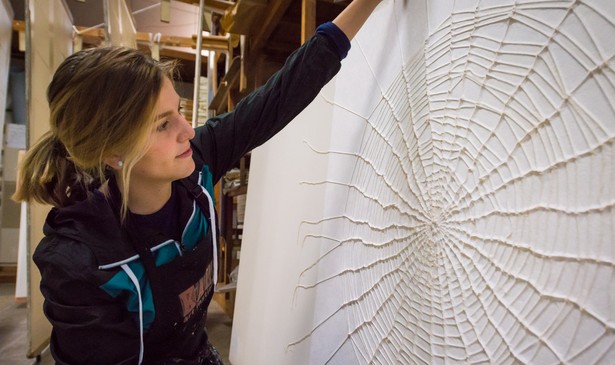 Artist Richelle Gribble with her cotton spider web on kozo washi paper, created during her artist-in-residency in Japan