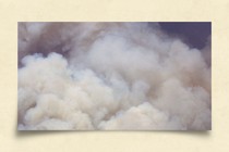 Clouds of smoke in front of a blue sky