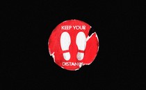 An illustration of a tattered sticker with footprints and the text "keep your distance"