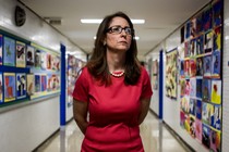 Eva Moskowitz looks sternly into the distance in a hallway in one of Success Academy's Harlem schools.