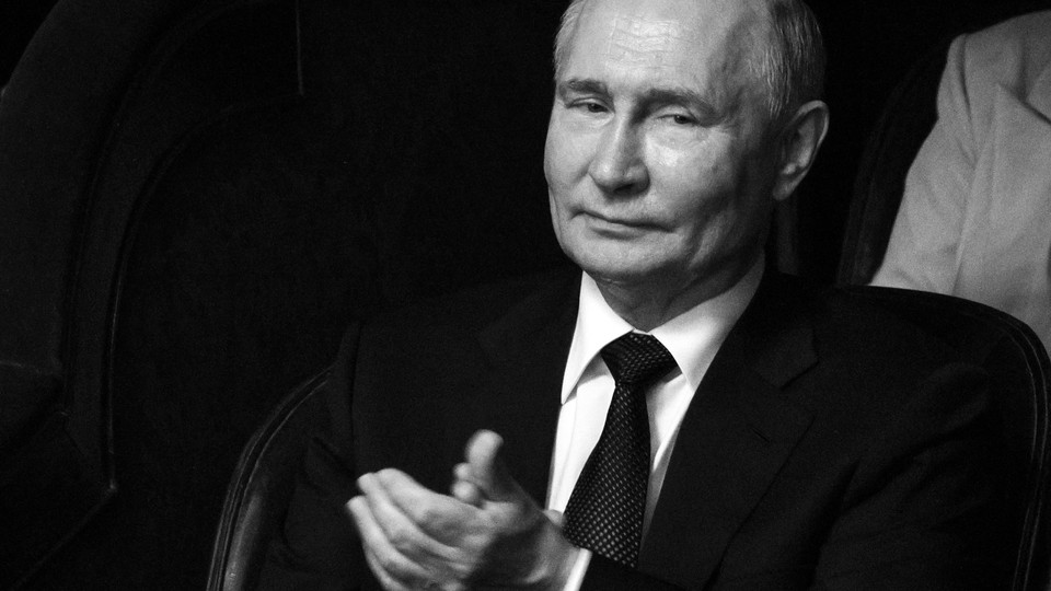A black-and-white photo of Vladimir Putin clapping with a disinterested expression.