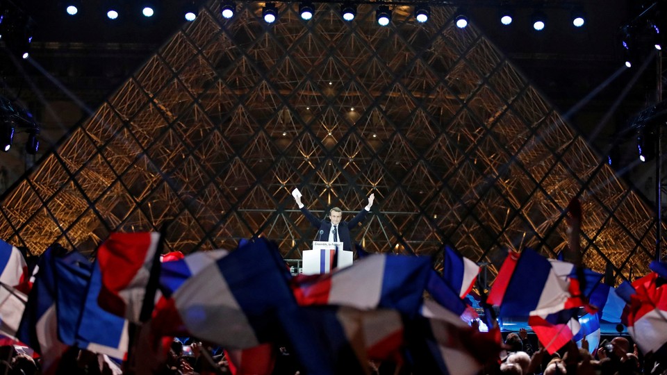 French President-elect Emmanuel Macron celebrates on the stage at his victory rally.