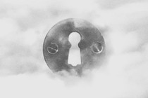A black-and-white drawing of a keyhole among clouds.