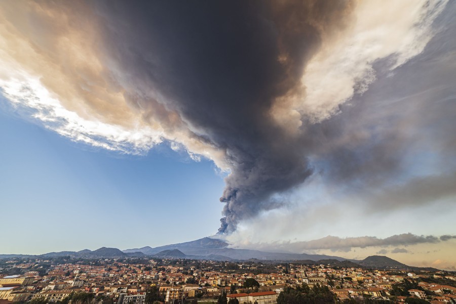 A column of volcanic ash rises from Mt. Etna.