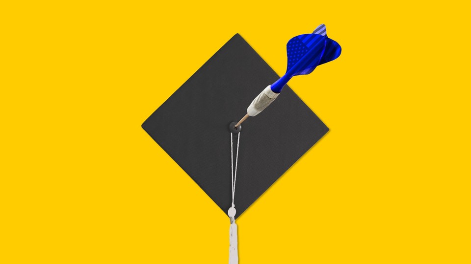 A graduation cap with an American flag–painted dart thrown into its center